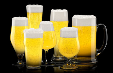 Set of fresh light beer glasses with bubble froth isolated on black background.
