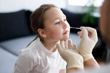 Father and daughter doing nasal test at home due to COVID-19 pandemic