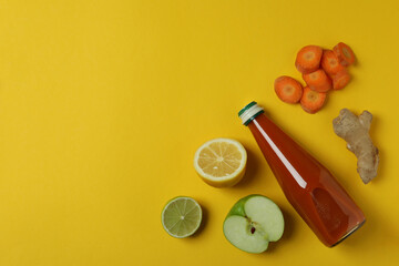 Fototapeta na wymiar Bottle of juice and ingredients on yellow background