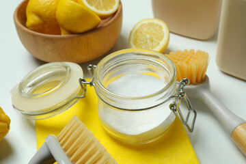 Cleaning concept with eco friendly cleaning tools and lemons on white background