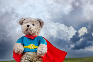 a brave super hero bear toy and stormy sky