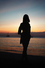 Fototapeta premium the lady at the beach at sunset