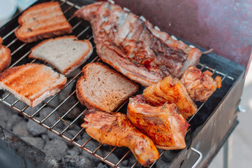 meat on barbecue grill with steam.Close up