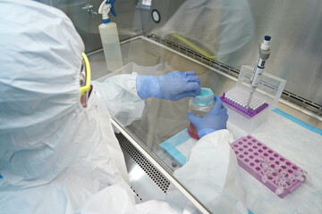 Almaty, Kazakhstan - 04.08.2021 : A virologist conducts tests for dangerous viruses and bacteria in...