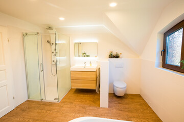 Beautiful, bright bathroom in country house style, with tiles in wood look. Large bathroom in a country house, with wood and white tiles 