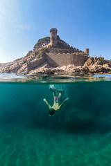 Little boy snorkeling with a castle in the background