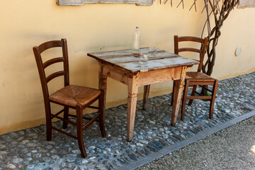 Wooden table with two chairs in the courtyard