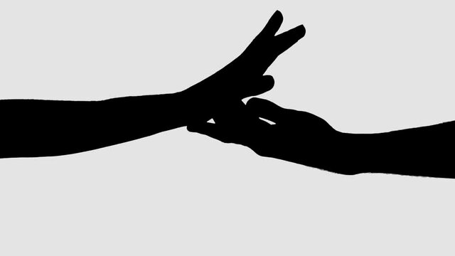 Silhouette of Love couple hands connecting. Closeup romantic people touching hands.
