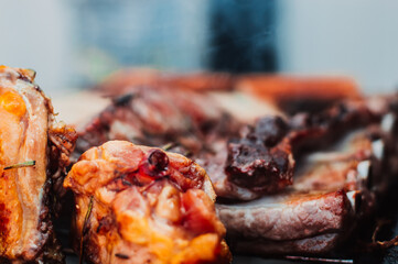 Chicken and beef on barbecue grill with steam.Close up