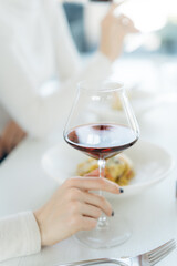 Person holding a glass of wine