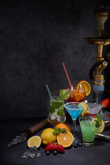 Hookah (shisha) and cocktails set on dark grey background. Hookah bar, cocktail bar. Party