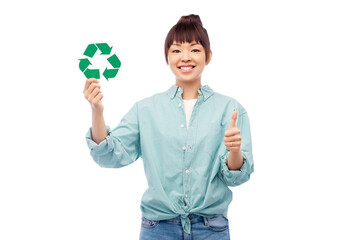 eco living, environment and sustainability concept - portrait of happy smiling young asian woman in turquoise shirt holding green recycling sign over grey background