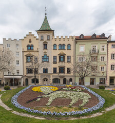 Town hall (Rathaus Municipio) and coat of arms made with flowers of Bressanone - Brixen. Trentino Alto Adige South Tyrol, Südtirol, Italy.