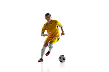 Young man, male soccer football player training isolated on white background.
