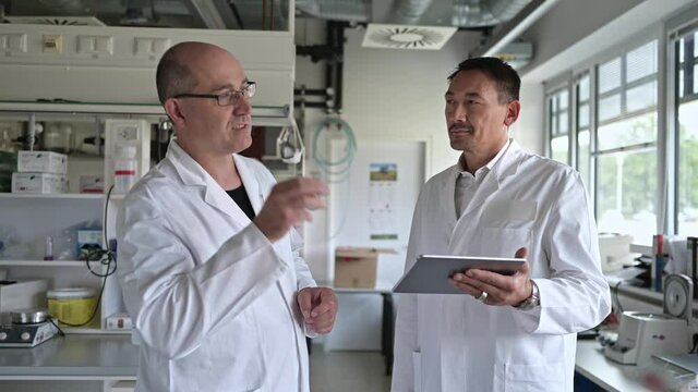 Scientists discussing research results in laboratory