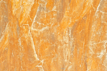 Texture of yellow and orange marble. Stone tile with natural pattern. Marble pavement closeup.