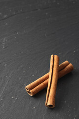 Cinnamon sticks on a slate background
