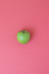 Natural and fresh green apple on pink background
