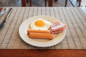 delicious breakfast with fried egg pork sausage and ham at the hotel