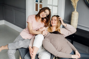 Cheerful group of happy female people clinking and toasting together with friendship and happiness - young and adult women