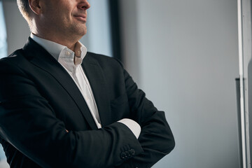 Businessman in black jacket standing in office