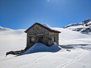 ski tour in austria near the border to switzerland. old customs house on the plasseggen pass. Wonderful winter landscape