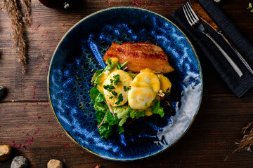 Poached egg on toast, with smoked bacon, and salad