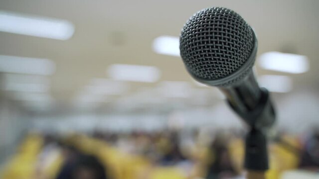 Microphone at lecture room or study classroom with Asian students taking an exam