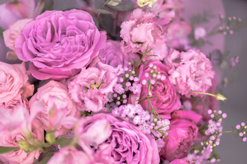 A lush bouquet of light pink, purple cute delicate small roses of different sizes, flowers. Close-up. Macro