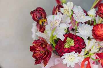 A bouquet of lush red white flowers of different sizes with green stems. Close-up.