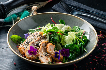 Slices of chicken breast fillet with green salad