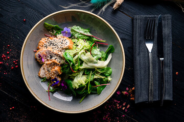 Slices of chicken breast fillet with green salad