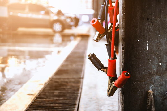 closeup battery charger in car repair center with soft-focus and over light in the background