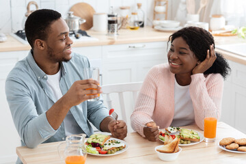 Cheerful Black Lovers Having Tasty Breakfast In Kitchen Together