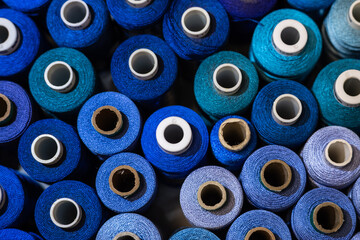 Spools of blue threads closeup