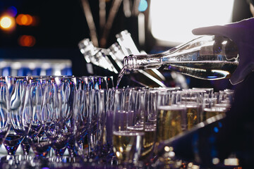 Waiter is pouring champagne into glasses, Champagne