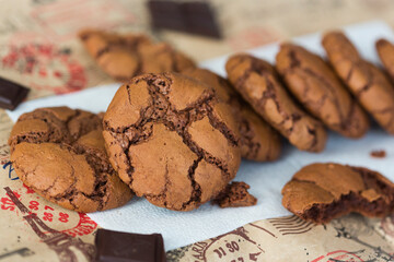 Homemade chocolate cookies brookies on white paper napkin and dark chocolate slices
