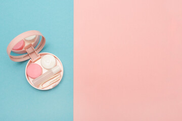 Travel kit for contact lenses. Pink color. Care and hygiene for colored contact lenses. Copy space. Text. 