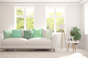 White living room with sofa and summer landscape in window. Scandinavian interior design. 3D illustration