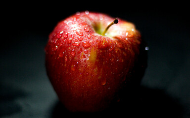 red apple on black background