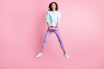 Fototapeta na wymiar Full length body size photo of jumping brunette girl laughing cheerfully isolated on pastel pink color background