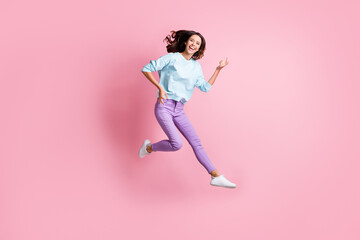 Fototapeta na wymiar Full length photo of young girl excited crazy have fun jump imagine play guitar isolated over pastel color background