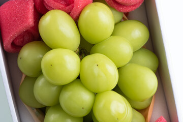 Beautiful boxed Shine Muscat green grape isolated on white background.
