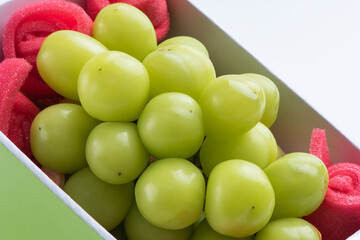 Beautiful boxed Shine Muscat green grape isolated on white background.