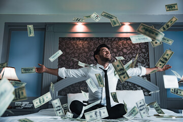 Successful businessmen celebrates success under money rain falling down dollar bills . Finances...