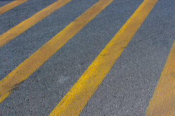 close up of asphalt road texture with yellow lines