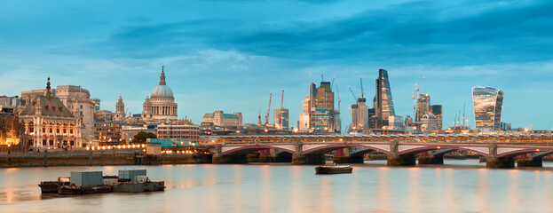 Fototapeta na wymiar London, panoramic aerial view over Thames river with St. Paul Cathedral, skyscapers of City and skyline.