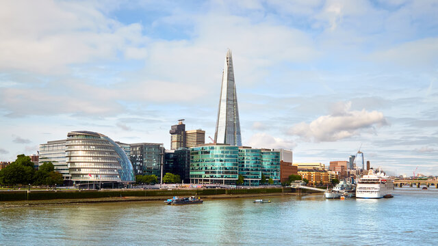 London, South Bank Of The Thames on a bright day in Summer. Panoramic image taken from the Tower Bridge.
