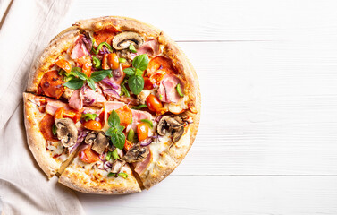 Traditional italian pizza with bacon and mushrooms on white wooden background, horizontal orientation, flat lay