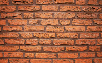abstract texture background of old brick wall in orange color with light glare